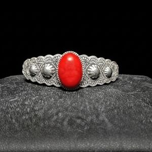 Intricate Silver Bracelet with Bold Red Accent